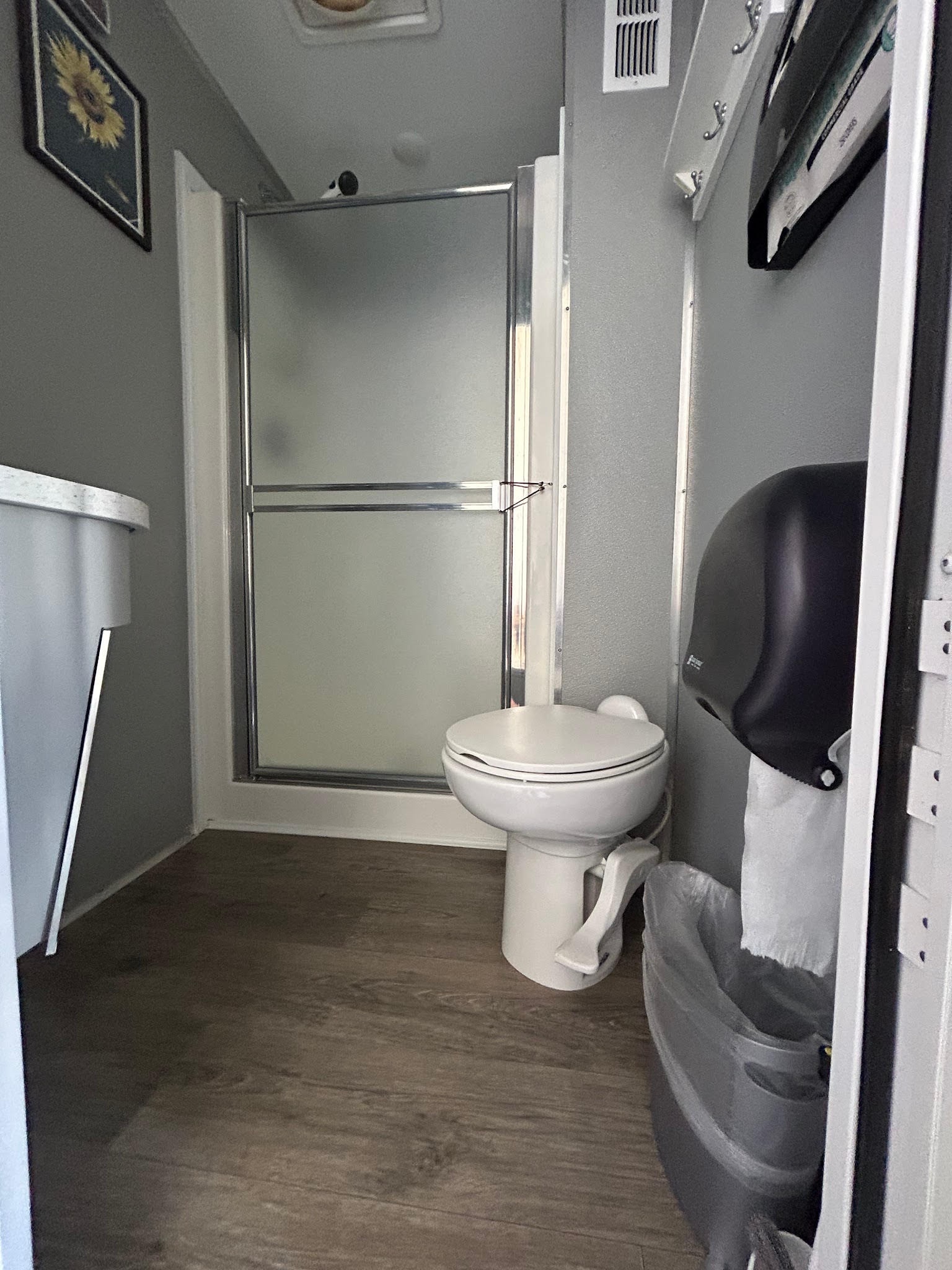 3-stall shower trailer interior — toilet and shower stall